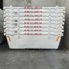 Stack of white industrial containers with rims stacked in a warehouse, red text reads 'DO NOT FILL ABOVE RIM' on each level.
