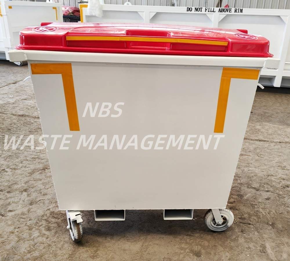 Large wheeled waste bin with a red lid, white body, and orange corner accents, labeled 'NBS WASTE MANAGEMENT'