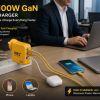 NBS FAST CHARGER | New Bridge Services Office desk with a yellow 100W GaN charger powering a phone, AirPods case, and laptop nearby in use by a person in a business setting