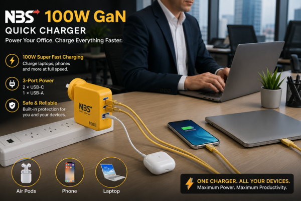 NBS FAST CHARGER | New Bridge Services Office desk with a yellow 100W GaN charger powering a phone, AirPods case, and laptop nearby in use by a person in a business setting